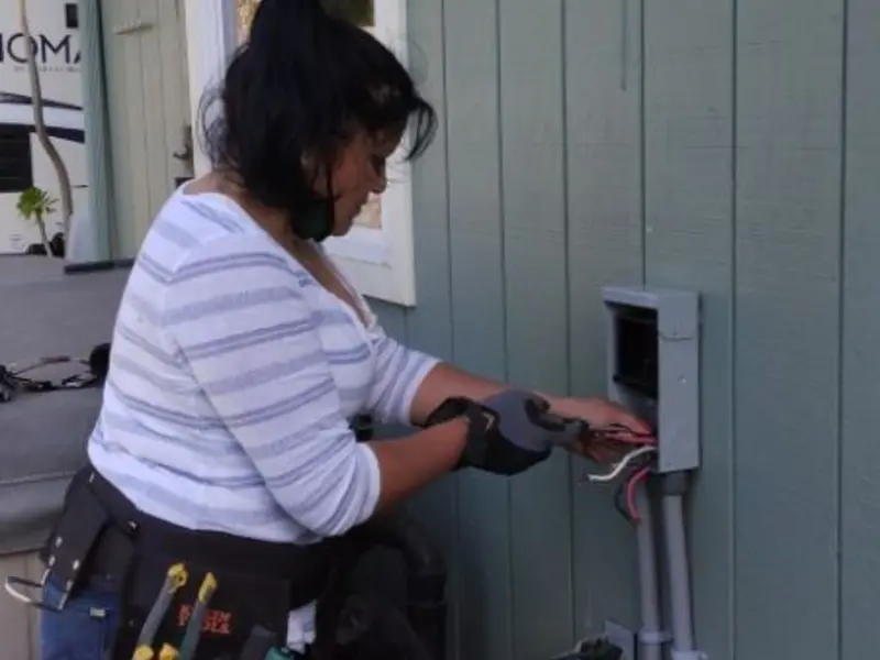 Licensed electrician wiring an exterior subpanel in Taymouth
